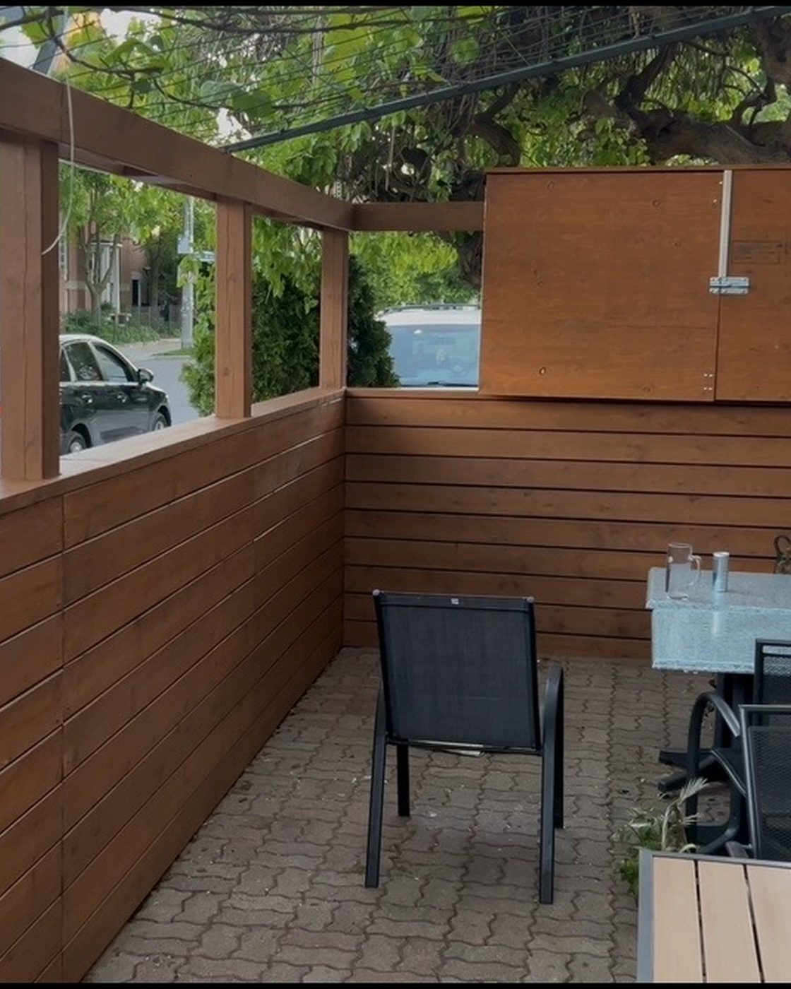 Patio fence after, rich brown stained wood pergola and privacy wall
