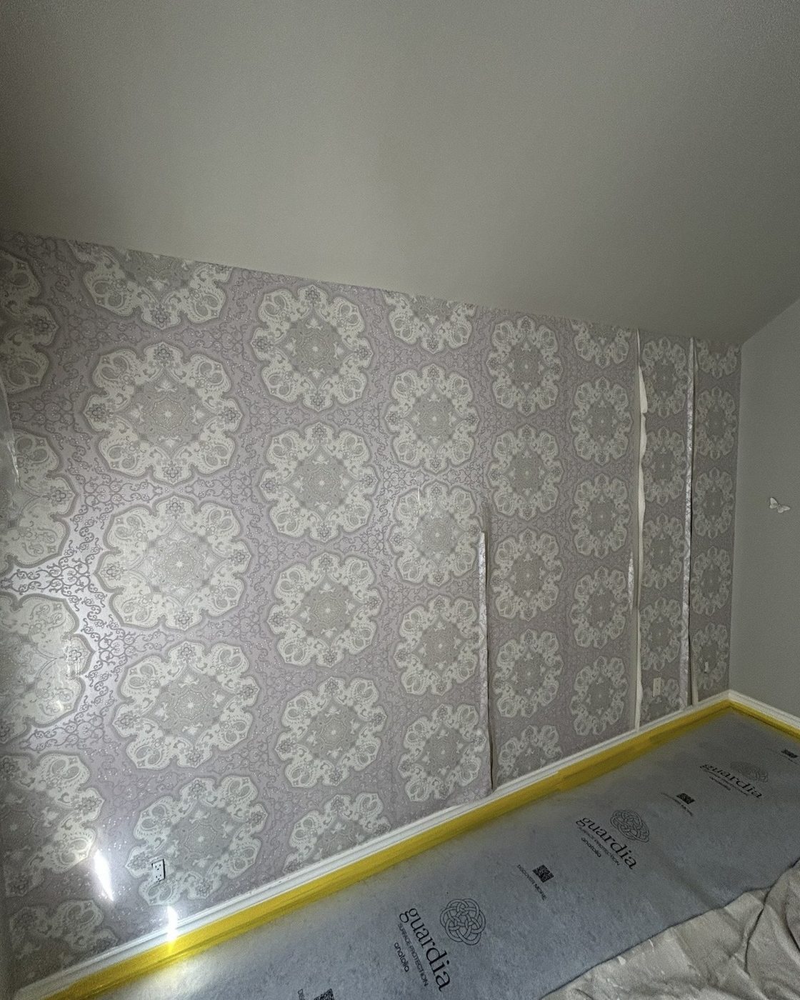Wall before, patterned silver and white damask wallpaper